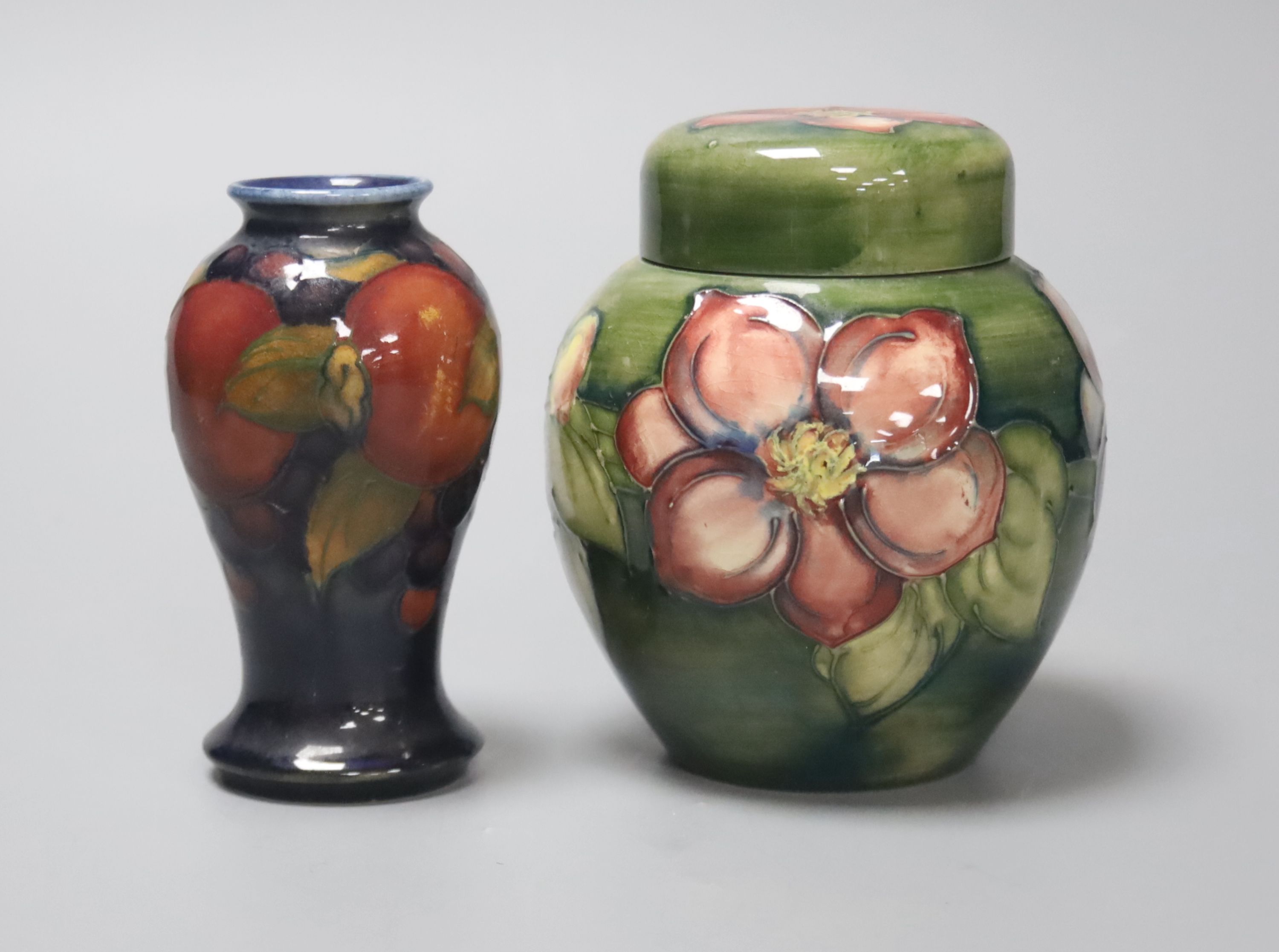 A Moorcroft Hibiscus jar and a similar Pomegranate vase, height 11cm